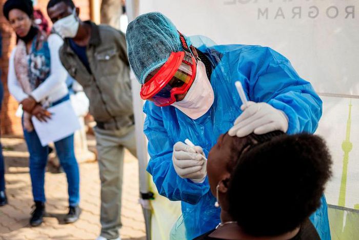 Doctors Without Borders nurse Bhelekazi Mdlalose performs a COVID-19 test on a health worker at the Vlakfontein Clinic in Johannesburg, South Africa on May 13, 2020.