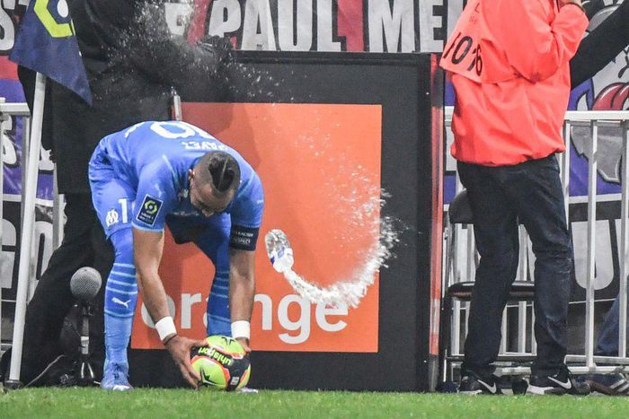Marseille's French midfielder Dimitri Payet (left) was hit by a bottle of water thrown from the stands during the Ligue 1 match against Lyon