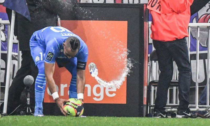 Marseille's French midfielder Dimitri Payet (left) was hit by a bottle of water thrown from the stands during the Ligue 1 match against Lyon