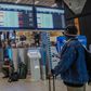 A passenger looks at an electronic flight notice board displaying cancelled flights at Tambo International Airport in Johannesburg on November 27, 2021, after several countries banned flights from South Africa following the discovery of a new coronavir...