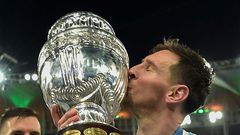Argentina's Lionel Messi kisses the trophy after winning the Copa America for the first time following a 1-0 win over Brazil