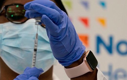Dr. Michelle Chester draws the Covid-19 vaccine into a syringe at Long Island Jewish Medical Center, on December 14, 2020 in the Queens borough of New York.