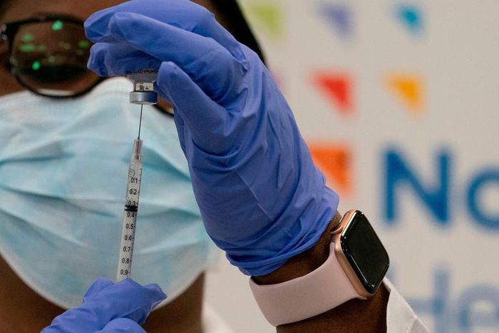Dr. Michelle Chester draws the Covid-19 vaccine into a syringe at Long Island Jewish Medical Center, on December 14, 2020 in the Queens borough of New York.