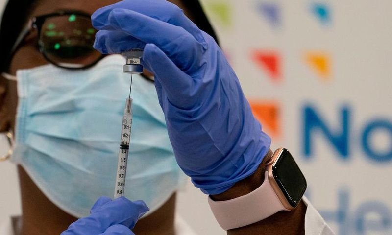 Dr. Michelle Chester draws the Covid-19 vaccine into a syringe at Long Island Jewish Medical Center, on December 14, 2020 in the Queens borough of New York.