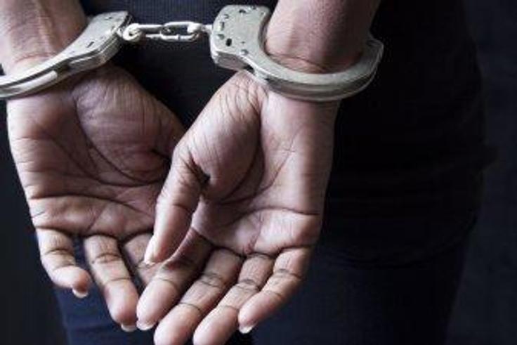 A woman .in handcuffs