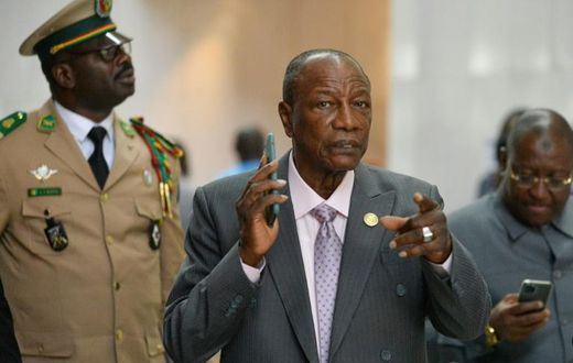 Alpha Conde, centre, became Guinea's first democratically-elected president in 2010 - today, critics say he has taken the well-worn path of authoritarianism