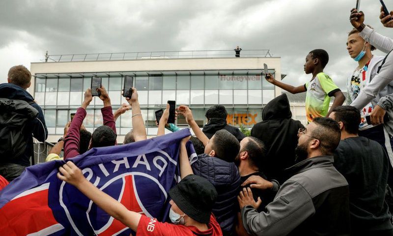 Expectant PSG supporters gather at Le Bourget airport just outside Paris on Monday, waiting for the possible arrival of Lionel Messi