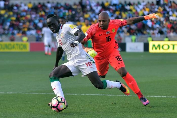 South Africa goalkeeper Itumeleng Khune (R) chases Senegal star Sadio Mane during a 2018 World Cup qualifer.