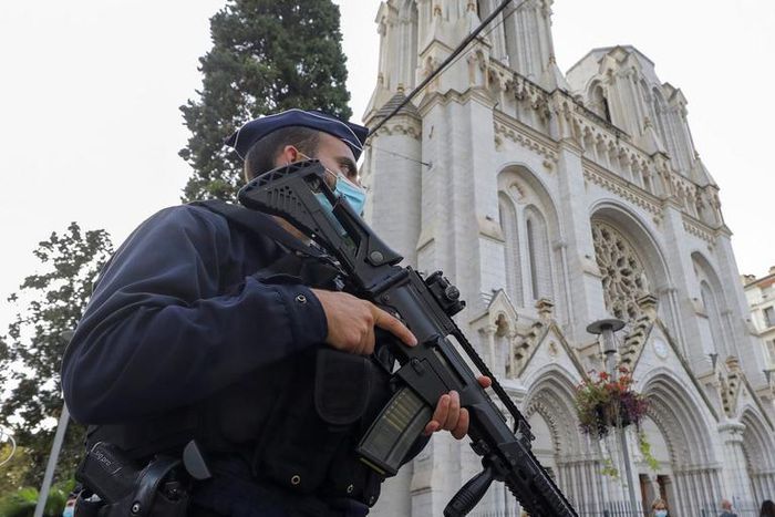 A police officer stands near Notre Dame church, where a knife attack took place, in Nice, France.