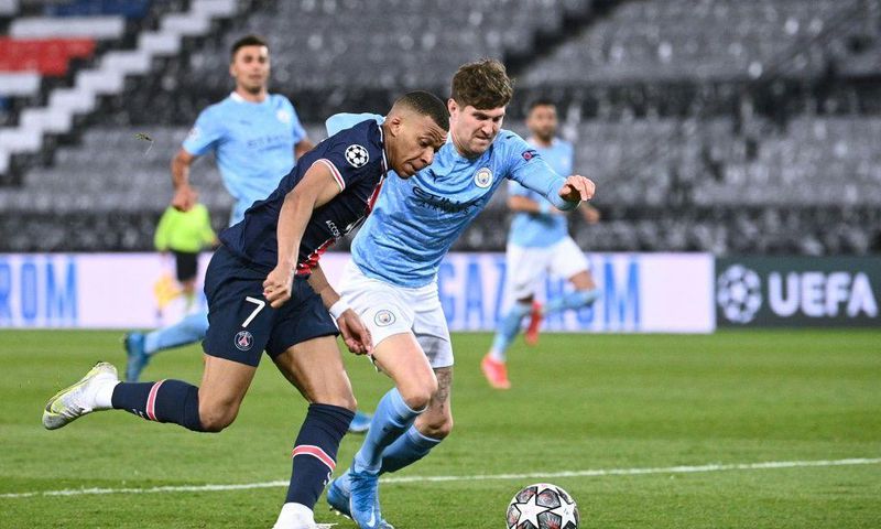 John Stones (right) helped keep PSG star duo Kylian Mbappe (left) and Neymar quiet