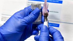 In this Monday, July 27, 2020 file photo, a nurse prepares a shot as a study of a possible COVID-19 vaccine, developed by the National Institutes of Health and Moderna Inc., gets underway in Binghamton, N.Y.