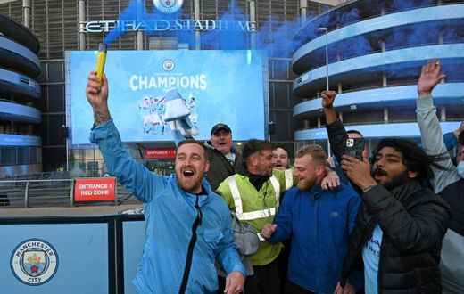 Manchester City fans celebrate winning the Premier League title