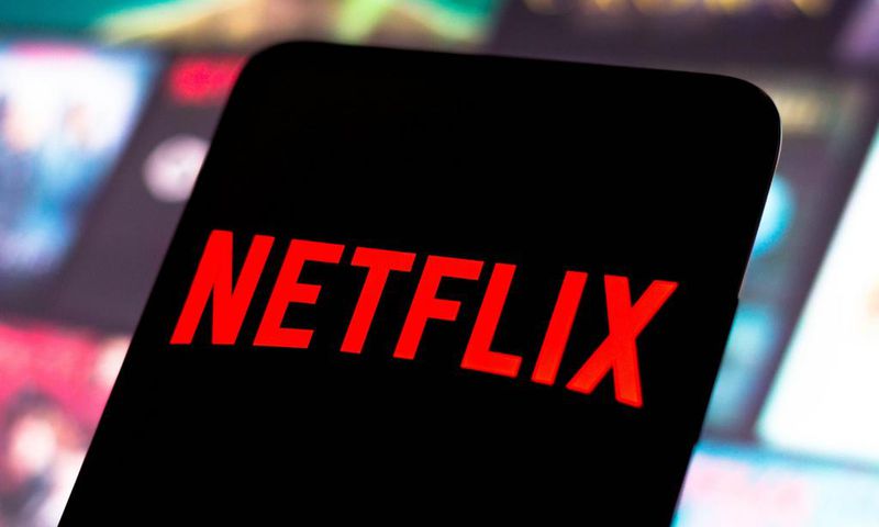 The Netflix logo is displayed on a smartphone screen.