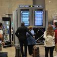 Travelers look at a departures board at Tel Aviv airport on October 7 as dozens of flights get canceled.Gil Cohen-Magen/AFP via Getty Images