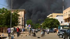 Smoke rises from the Burkinabe capital Ouagadougou from a jihadist attack in March 2018. Eight soldiers and eight assailants died, according to an official toll