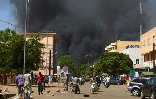 Smoke rises from the Burkinabe capital Ouagadougou from a jihadist attack in March 2018. Eight soldiers and eight assailants died, according to an official toll