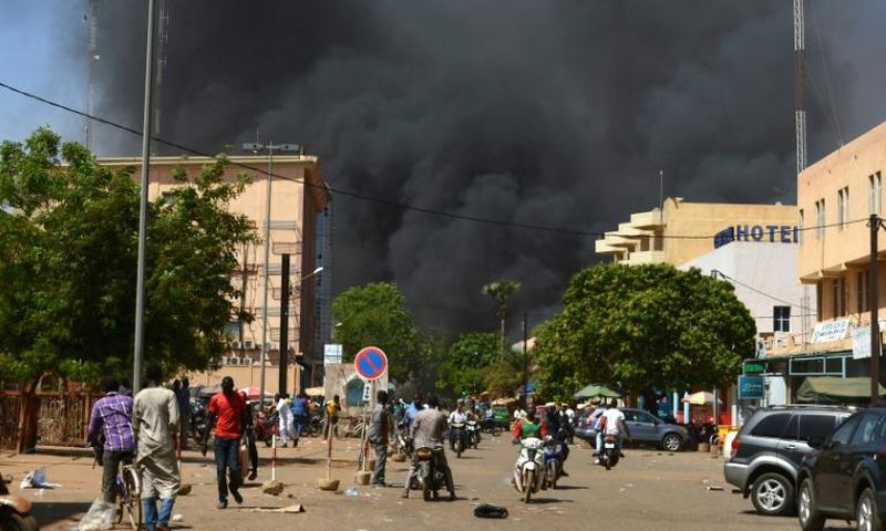 Smoke rises from the Burkinabe capital Ouagadougou from a jihadist attack in March 2018. Eight soldiers and eight assailants died, according to an official toll