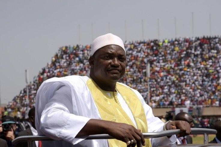 Gambian President Adama Barrow looks at the audience from the roof of a car as he arrives at the Independence Stadium in Bakau, west of the capital Banjul for his inauguration ceremony, on February 18, 2017