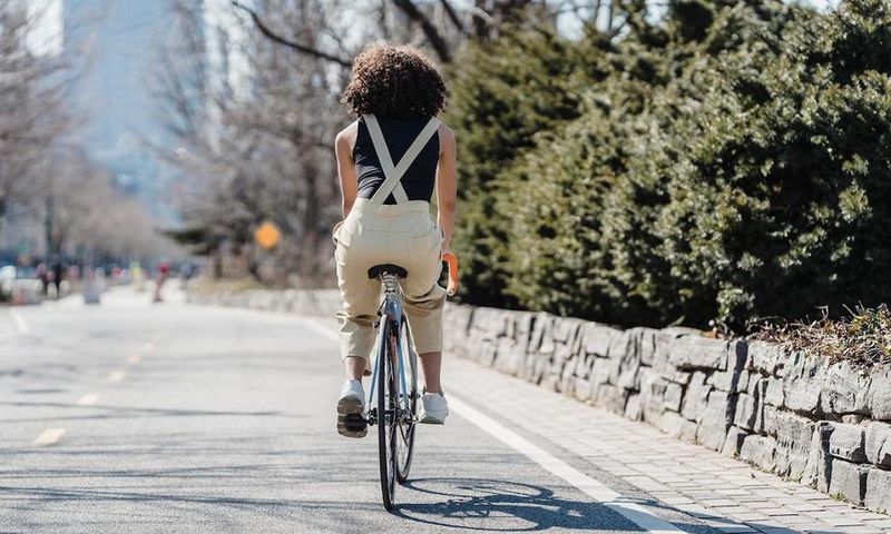 Cyclist riding bicycle on a city street [Photo: Blue Bird]