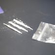 A stock photo shows a bag of cocaine with lines of the drug.Getty Images