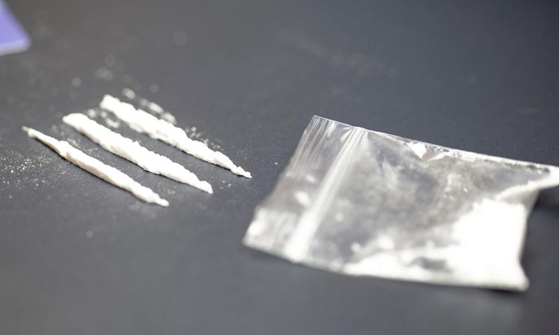 A stock photo shows a bag of cocaine with lines of the drug.Getty Images