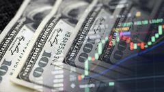 Cash dollars and stock market indicators (inflation, economy, crisis, finance)Getty Images