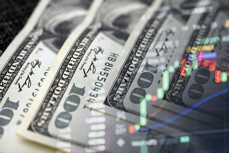 Cash dollars and stock market indicators (inflation, economy, crisis, finance)Getty Images