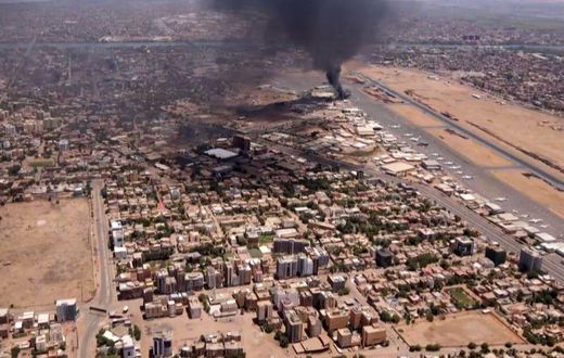 This image taken from AFPTV video footage on April 20, 2023, shows black smoke rising above the Khartoum International Airport amid ongoing fighting in Sudan.AFP via Getty Images