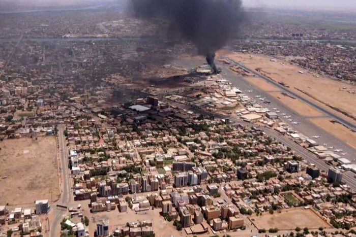 This image taken from AFPTV video footage on April 20, 2023, shows black smoke rising above the Khartoum International Airport amid ongoing fighting in Sudan.AFP via Getty Images