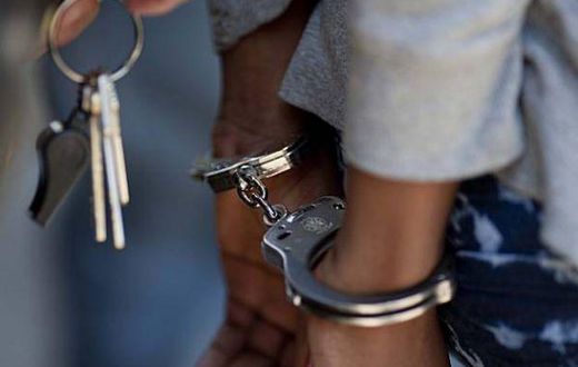 A woman in handcuffs