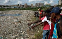 1444x920 correction-a-man-points-towards-a-body-while-standing-with-others-on-the-edge-of-a-dumpsite-where-six-bodies-were-found-at-the-landfill-in-mukuru-slum-nairobi-on-july-12-2024-kenyan-police-have-annou