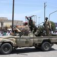 Sudanese greet army soldiers, loyal to army chief Abdel Fattah al-Burhan, in the Red Sea city of Port Sudan on April 16, 2023.AFP via Getty Images