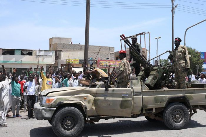 Sudanese greet army soldiers, loyal to army chief Abdel Fattah al-Burhan, in the Red Sea city of Port Sudan on April 16, 2023.AFP via Getty Images