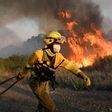 Firefighters try to extinguish a wildfire next to the village of Tabara, near Zamora, northern Spain, on Monday.