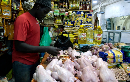 Un vendeur de poulets prépare des viandes à vendre sur un marché de Bambilors à Dakar, le 4 mai 2018. (Photo VOA)