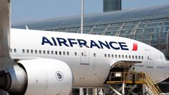 Airport workers load an Air France Boeing 777 parked in the tarmac at Charles de Gaulle Airport in Paris.