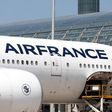 Airport workers load an Air France Boeing 777 parked in the tarmac at Charles de Gaulle Airport in Paris.