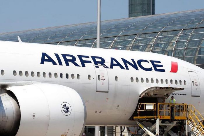 Airport workers load an Air France Boeing 777 parked in the tarmac at Charles de Gaulle Airport in Paris.