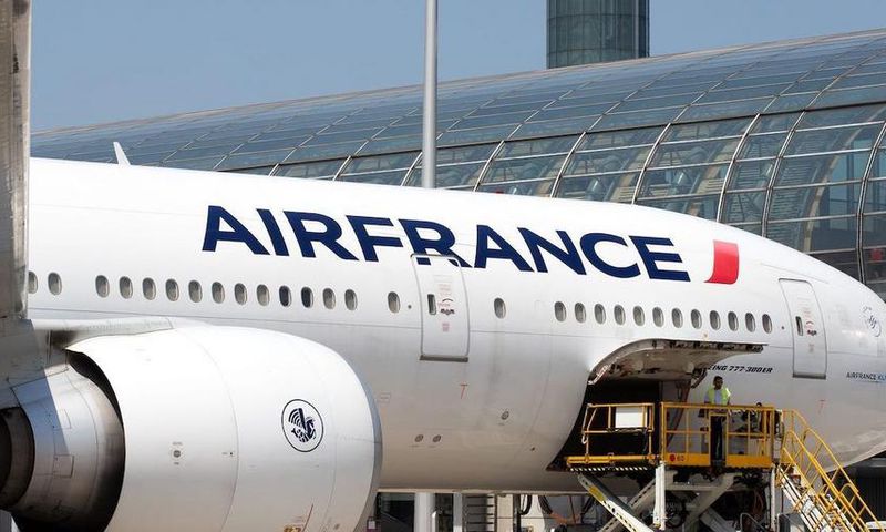 Airport workers load an Air France Boeing 777 parked in the tarmac at Charles de Gaulle Airport in Paris.