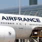 Airport workers load an Air France Boeing 777 parked in the tarmac at Charles de Gaulle Airport in Paris.