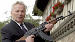 ussian general Mikhail Kalashnikov poses with his famous assault rifle in 2002