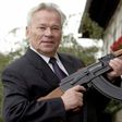 ussian general Mikhail Kalashnikov poses with his famous assault rifle in 2002