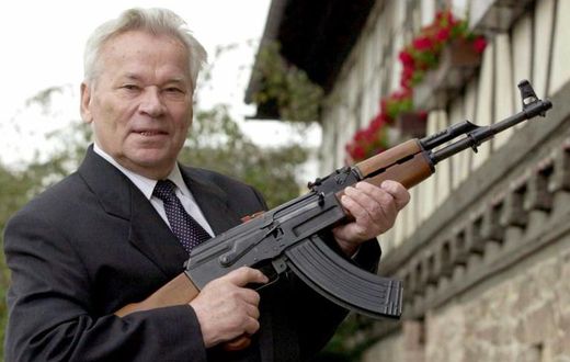 ussian general Mikhail Kalashnikov poses with his famous assault rifle in 2002