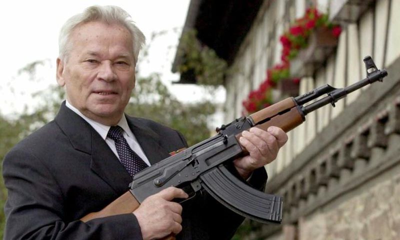 ussian general Mikhail Kalashnikov poses with his famous assault rifle in 2002