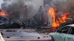 People try to extinguish a fire in Ashkelon, Israel, after Hamas launched a series of surprise attacks on October 7.Ahmad Gharabli/AFP via Getty Images