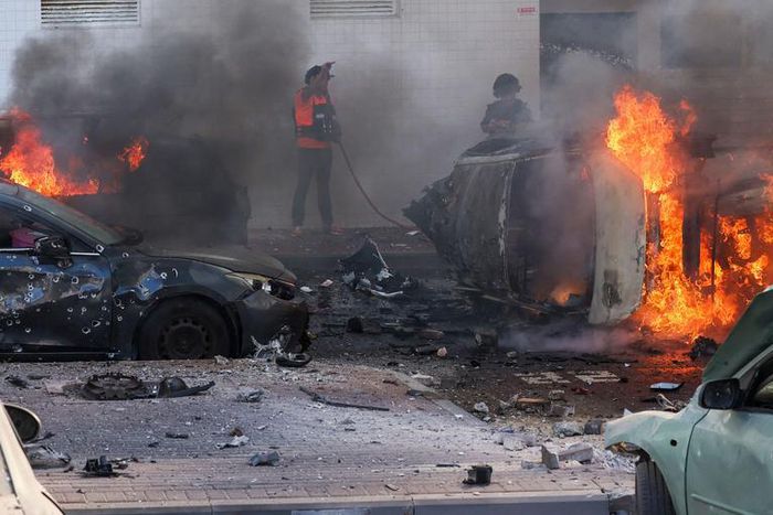 People try to extinguish a fire in Ashkelon, Israel, after Hamas launched a series of surprise attacks on October 7.Ahmad Gharabli/AFP via Getty Images