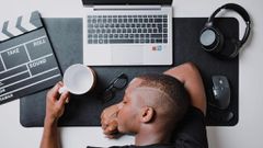 a-man-sitting-at-a-desk-with-a-laptop-and-headphones-stockpack-unsplash-scaled