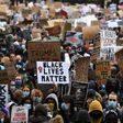 Protesters hold placards as they attend a demonstration in Parliament Square in central London on June 6, 2020, to show solidarity with the Black Lives Matter movement in the wake of the killing of George Floyd, an unarmed black man who died after a po...