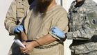 A detainee is escorted by military guards at the US prison at Guantanamo Bay, Cuba, in a 2006 photo