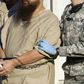 A detainee is escorted by military guards at the US prison at Guantanamo Bay, Cuba, in a 2006 photo